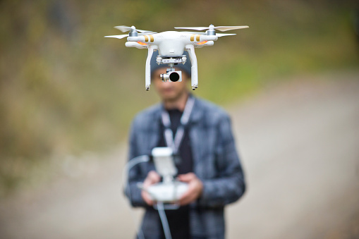 A man takes video footage with his helicopter drone.