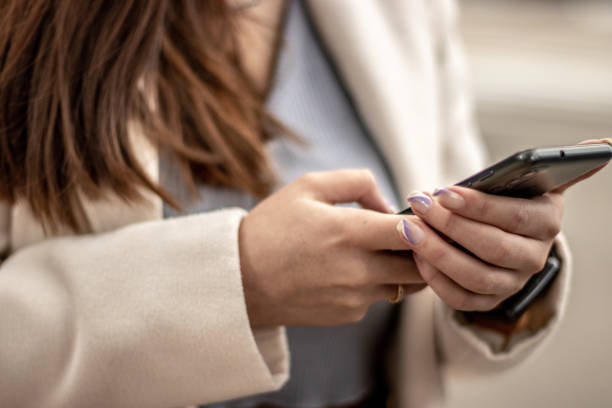istock Close-up of a woman using mobile phone 1470012059