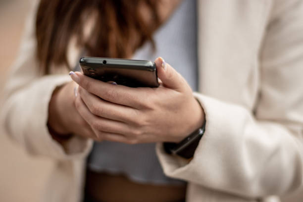 istock Close-up of a woman using mobile phone 1470012060