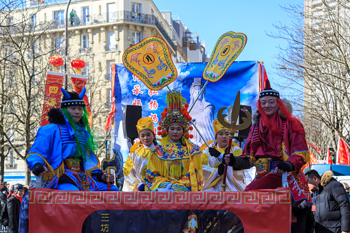 Paris, France-February 25,2018: Group of traditional characters in a float during the 2018 Chinese New year parade in Paris.