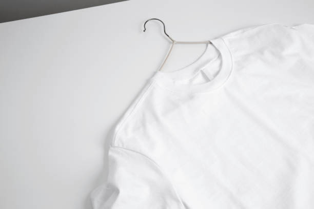 istock Basic white t-shirt and hanger on table. Mock up for branding t-shirt. Copy space 1470014118