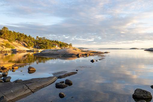 Southern Norway, quiet little village by the sea shore looking like a reflection lake.