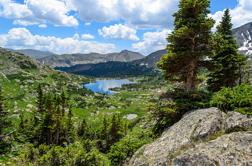 Beaver lake landscape from hiking trail in Beaver Creek ski resort near Avon, Colorado with water surface in summer in Holy Cross Wilderness and spruce tree forest