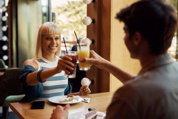 istock Happy couple toasting with fresh juice in cafe. 1470018413