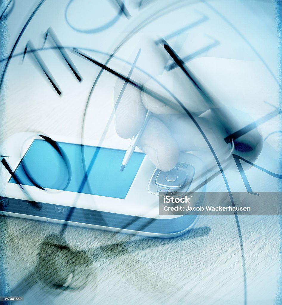 Human hand working on pda against a clock Human hand working on pda against a clock. Digital Clock Stock Photo