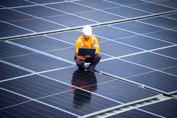 istock Renewable energy sources and solar engineer checking photovoltaic panels and electricity production. 1470021435