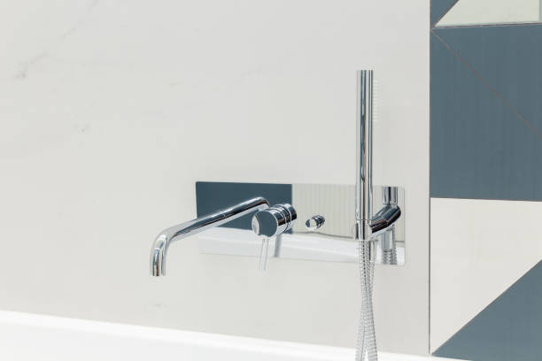 istock Ultra modern bathroom in stark white with silver faucet. 1470022988