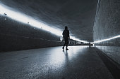 person in black clothes in underground passage