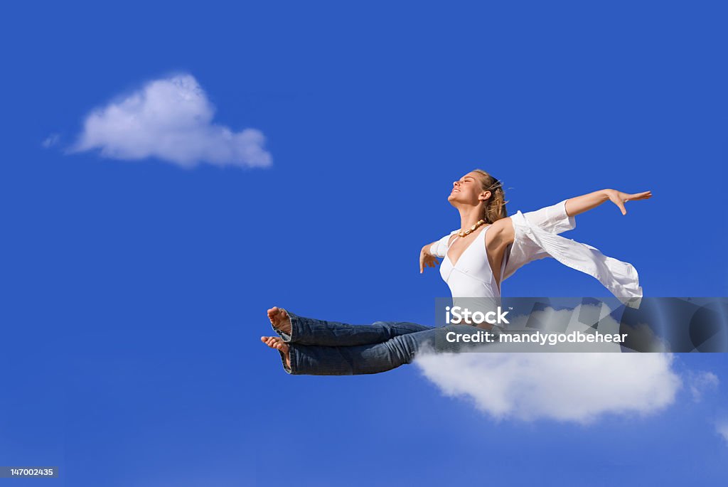 Blonde woman with head in the clouds travel concept, woman floating on cloud Adult Stock Photo
