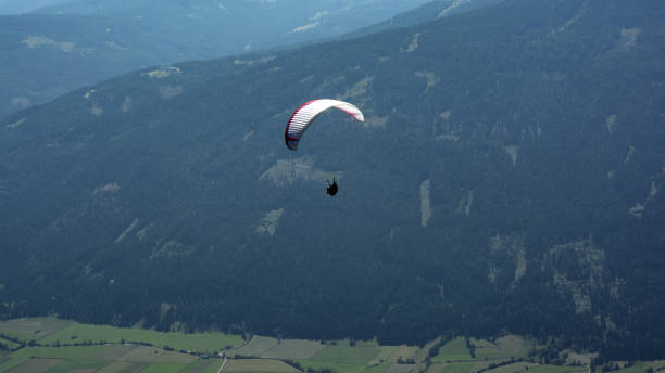 istock paraglider flying far away in a valley in St. Lungau 1470024568