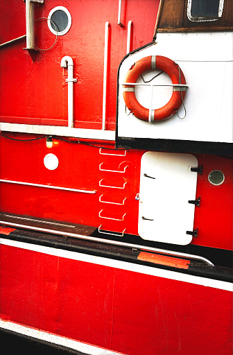 Abstract of the red coloured exterior of a boat