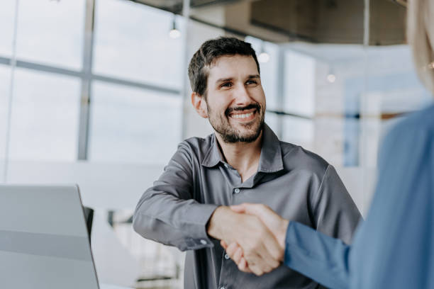istock Business man shaking hands with a woman 1470025514
