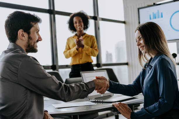 istock Business woman shaking hands with a man 1470025524