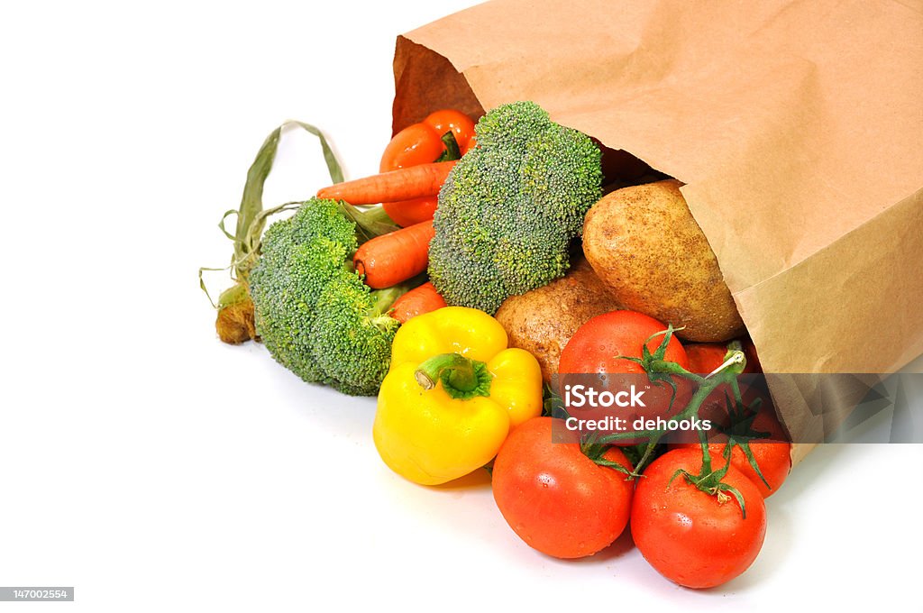 Vegetables in Grocery Bag Health food in grocery bag isolated on white background. Groceries Stock Photo