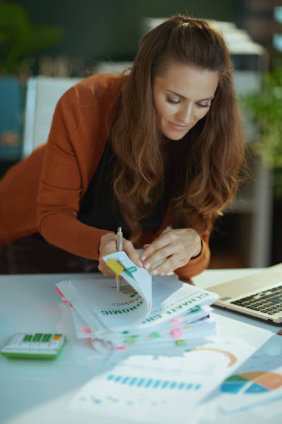 istock business owner woman in green office working with documents 1470025580