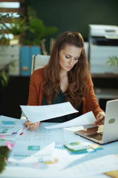 istock business owner woman in green office working with documents 1470025583