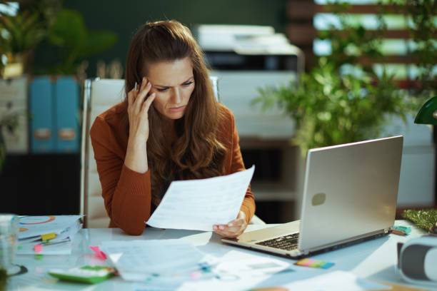 istock business owner woman in green office working with documents 1470025585