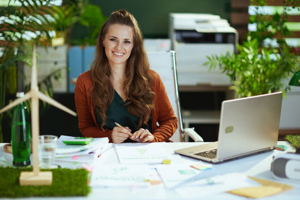 business owner woman in green office working with documents stock photo