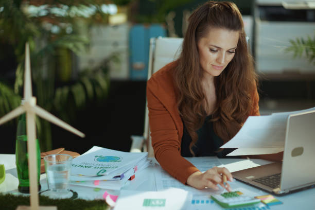 business owner woman in green office working with documents