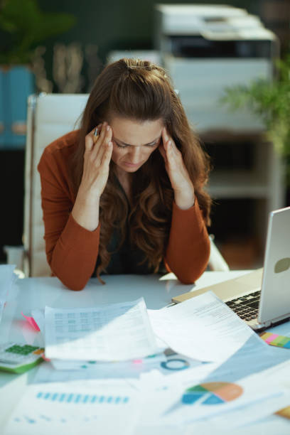 istock business owner woman in green office working with documents 1470025599
