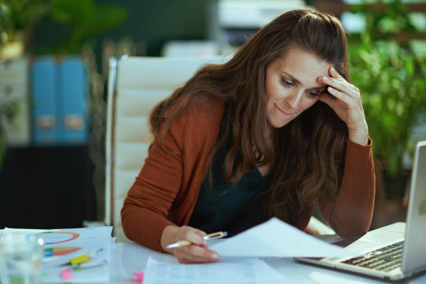 istock business owner woman in green office working with documents 1470025603