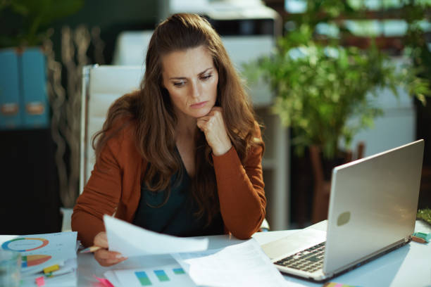 istock business owner woman in green office working with documents 1470025605