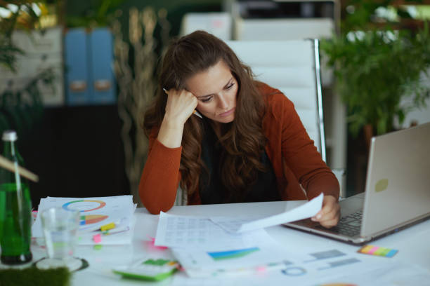 istock business owner woman in green office working with documents 1470025610