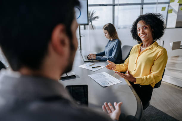 istock Coworkers talking at business meeting 1470025646