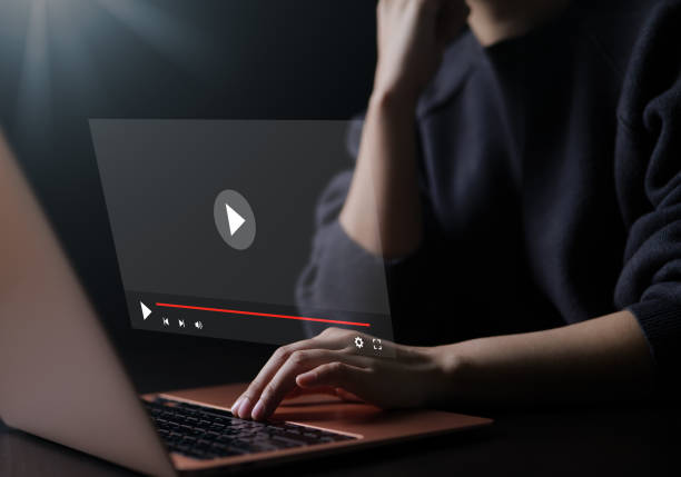 istock Woman using a computer for streaming online on virtual screen, watching video on the internet, live content, show or tutorial, content online, live concert, broadcast online, digital media, webinar, 1470027072