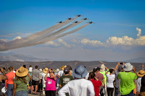 San Francisco, United States – October 07, 2023: A formation of five fighter jets flying in unison against a clear blue sky background