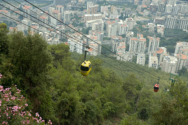 Téléferique Plunging view of Jounieh, Lebanon, with a view of two cabelcars above the trees and bush. alintal stock pictures, royalty-free photos & images