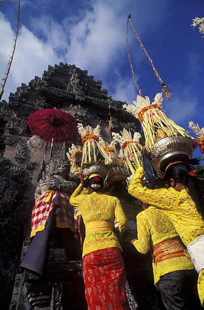 istock Balinese Women in Temple Procession with Offerings 147002909