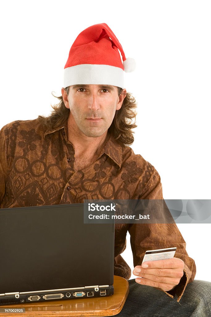 ノートパソコンのクリスマスのオンラインショッピングの中年男性 - 1人のロイヤリティフリーストックフォト