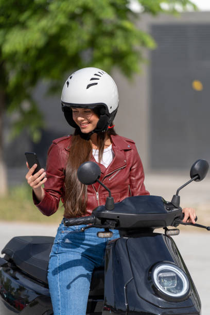 istock Biker using mobile phone on his motorcycle outdoors 1470030727