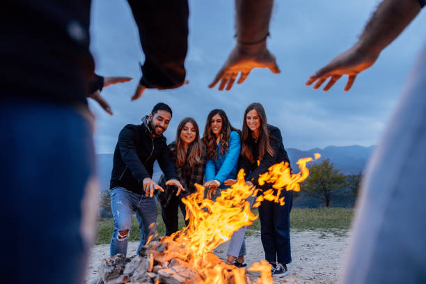 istock Happy group of friends in a circle around a bonfire 1470031640