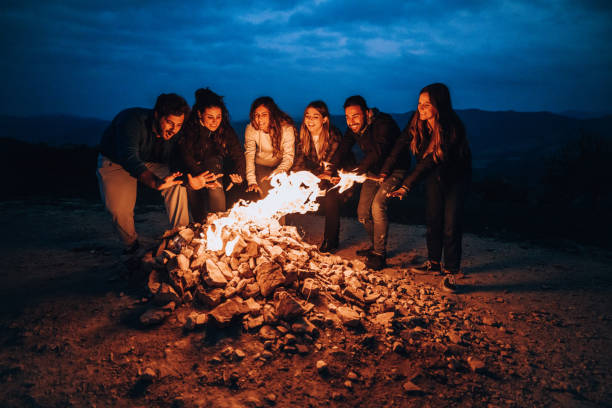 istock Happy group of friends in a circle around a bonfire 1470032280