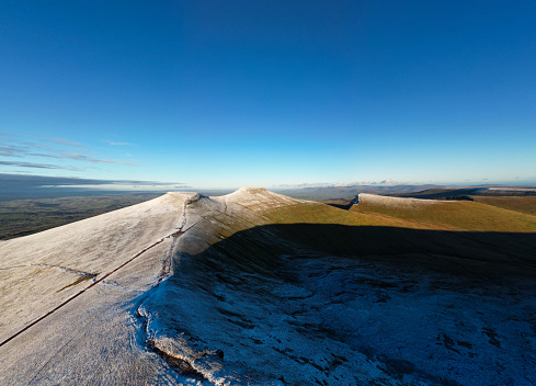 Aerial view of a snow capped Corn Du, Pen-y-Fan and Cribyn in the Brecon Beacons (Wales)