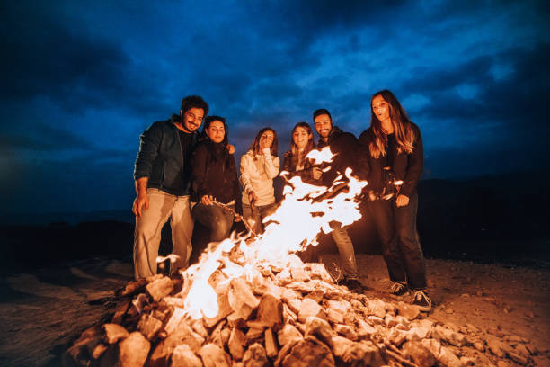 istock Happy group of friends in a circle around a bonfire 1470032341