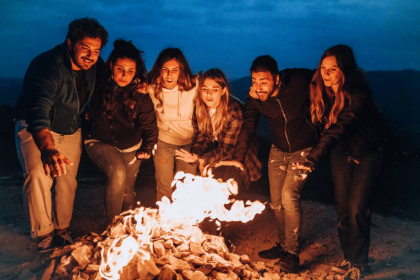 istock Happy group of friends in a circle around a bonfire 1470032414