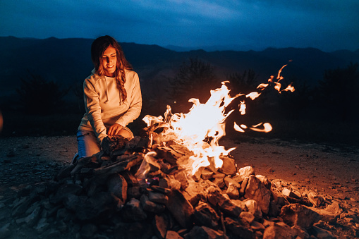 Woman close to a bonfire