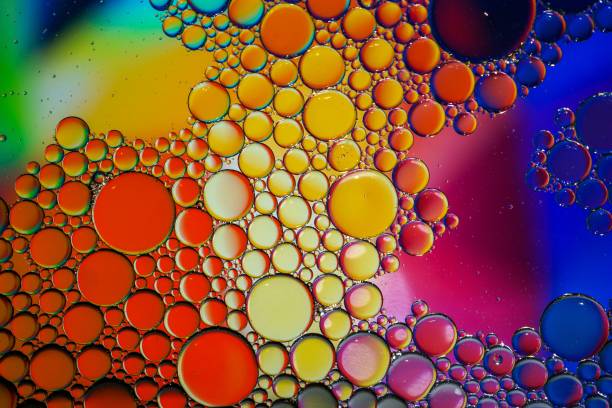 istock multi colored oil circles on the water, colorful background 1470032791