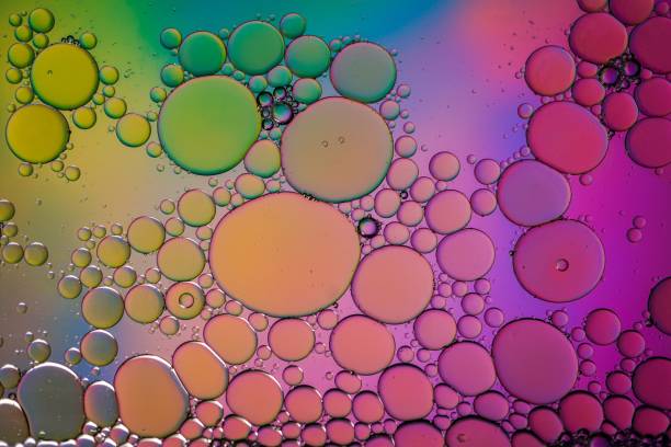 istock multi colored oil circles on the water, colorful background 1470032793