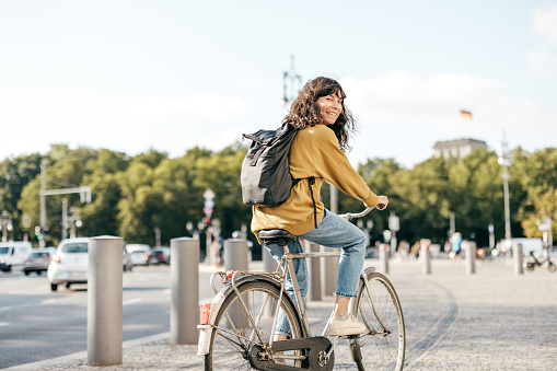 Young woman biking in a city - stock photo