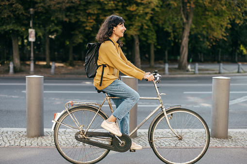 Young woman biking in a city - stock photo