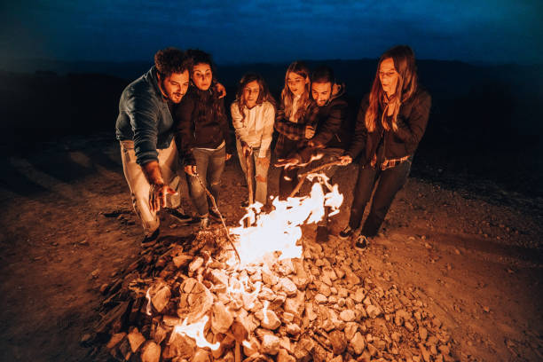 istock Happy group of friends in a circle around a bonfire 1470034081