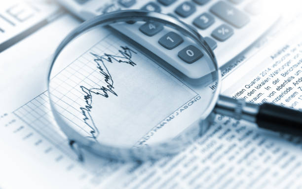 istock Magnifying glass, calculator and charts on paper 1470034194
