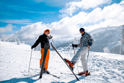 Happy couple on Ski Holiday in Snow Mountains. Copy space