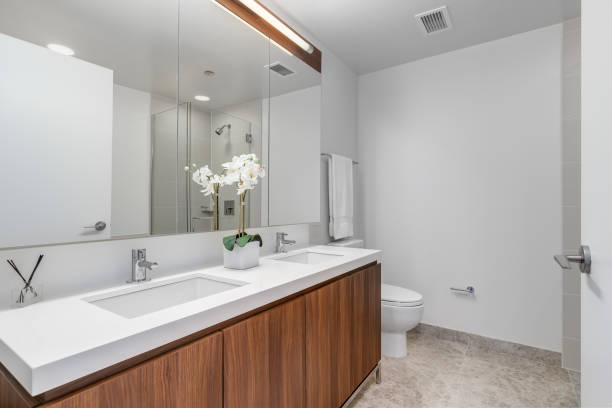 istock A bathroom with a wood cabinet and white marble countertop. 1470035499