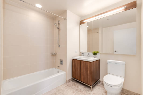 istock A bathroom with a small wood cabinet and tiled shower. 1470035506