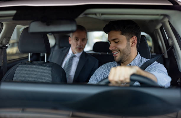 Passenger talking to his crowdsourced taxi driver Passenger talking to his crowdsourced taxi driver in the car - transportation concepts taxi driver stock pictures, royalty-free photos & images